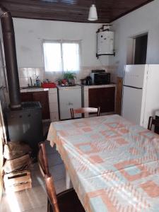 una cucina con un tavolo e una cucina con un fornello di La casita a Pringles