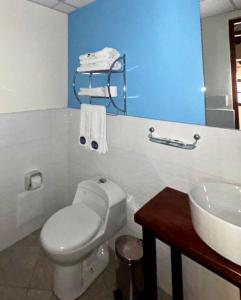 a bathroom with a white toilet and a sink at ViaVia Ayacucho in Ayacucho