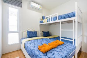 a bedroom with a bunk bed with an orange pillow on it at Sea Fan Cha-am Pool Villa in Ban Bo Prakhon