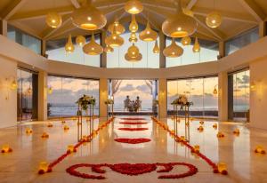 a lobby with red flowers on the floor at The Seminyak Beach Resort & Spa in Seminyak +104 photos