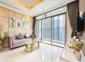 a living room with a couch and a table at Luminous Landmark Apartment in Ho Chi Minh City +42 photos