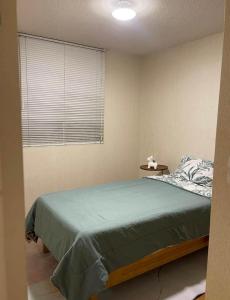 a bedroom with a large bed and a window at Acogedora habitación in Lima