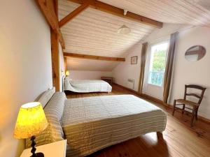 a bedroom with two beds and a lamp in a room at Gite de lescurade in Escource