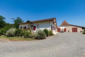 a house with a gravel driveway in front of it at Bachale in Lamothe