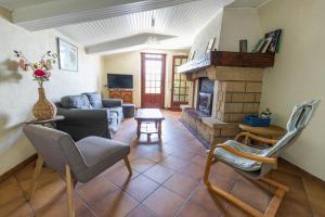 a living room with a couch and a fireplace at Bachale in Lamothe