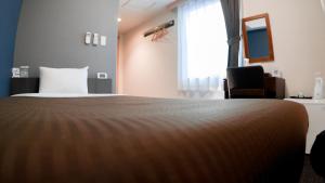 Postel nebo postele na pokoji v ubytování Arigato Stay Kanazawa Katamachi + 32 fotografií