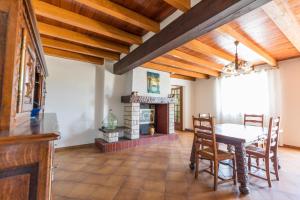 a dining room with a table and a fireplace at Bachale in Lamothe