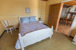 a bedroom with a white bed and a chair at Bachale in Lamothe +29 photos