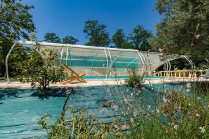 a glass bridge over a pool in a garden at Bachale in Lamothe