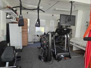 a room with a gym with bikes and a tv at vacation paradise in Ararat