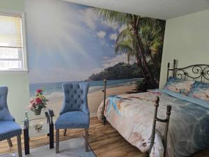 a bedroom with a mural of a beach and palm trees at vacation paradise in Ararat +100 photos