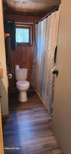 a small bathroom with a toilet and a window at Brown Family Farm in Grand Forks