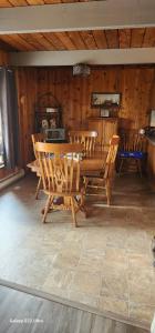 a wooden dining room with a table and chairs at Brown Family Farm in Grand Forks +13 photos