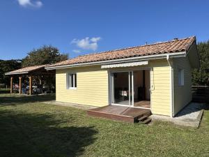 a small yellow house with a wooden deck at Prejean in Léon +12 photos