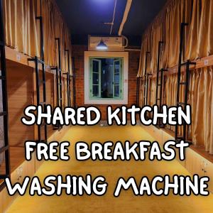 a train car with the words shared kitchen free breakfast machine at Mi Amor Luxury Hostel located in South Island Center in Phu Quoc