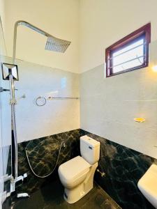 a bathroom with a toilet and a shower and a sink at Green Hill Villa Thalpe in Talpe +40 photos