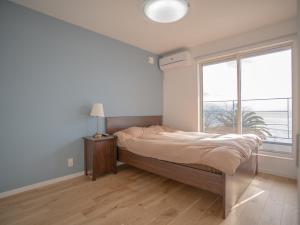 Postel nebo postele na pokoji v ubytování 新築サーファーズハウス棟貸しFLAG Awaji