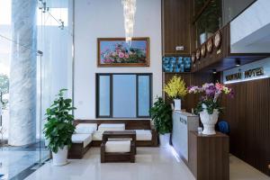 a lobby with a waiting area with plants and flowers at Nam Hai Con Dao Hotel in Con Dao