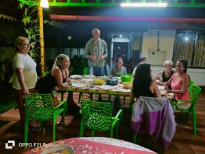 a group of people sitting around a table at sea scape homestay in Mararikulam