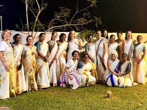 a group of people are posing for a picture at sea scape homestay in Mararikulam