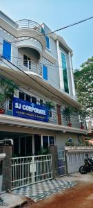 a building with a blue sign on the side of it at Hotel SJ corporate in Bhubaneshwar