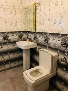 a bathroom with a white toilet and a sink at Ora Safari Resort in Udawalawe +53 photos