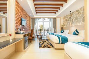 a hotel room with two beds and a kitchen at Tulsi Kathmandu Hotel in Kathmandu