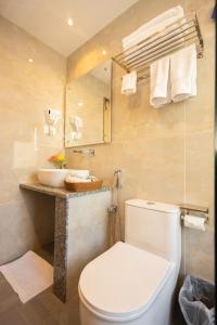 a bathroom with a toilet and a sink at Tulsi Kathmandu Hotel in Kathmandu