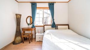 Postel nebo postele na pokoji v ubytování Gapyeong ojeupension