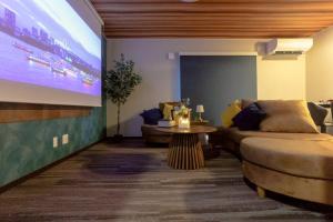 a living room with a couch and a large screen at Pine21 TOHOKU 