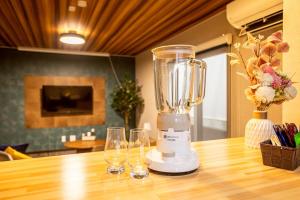 a blender sitting on top of a table with two glasses at Pine21 TOHOKU  +40 photos