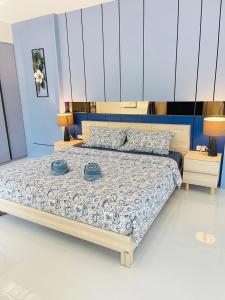 a bedroom with a bed with two hats on it at 3BR Pool Villa Beach Access Patumnak Hill in Pattaya South +33 photos