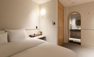 a hotel room with a bed and a bathroom at 호텔인카페 파주금촌점 in P'aju