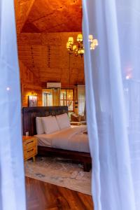 a bedroom with a bed with a wooden ceiling at Kilimani Villa in Moshi +26 photos