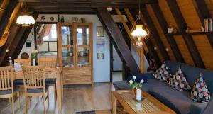 a living room with a blue couch and a table at Haus Sternenblick 22 in Freyung