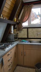 a small kitchen with a sink and a window at Haus Sternenblick 22 in Freyung