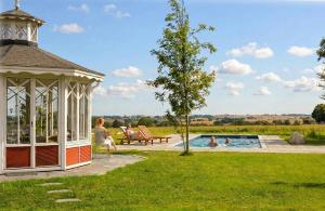 a gazebo and a pool in a yard at Torsborgs Gård in Simrishamn
