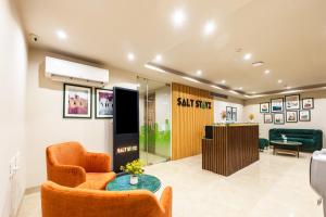a lobby with a waiting room with a chair and a desk at Saltstayz Select- Medicity Near Medanta Hospital in Gurgaon