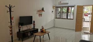 a living room with a tv and a table at Hey homestay melaka in Melaka +36 photos