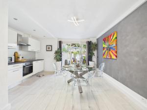 a kitchen and dining room with a glass table and chairs at Les Lodges de Saint Cassien in Montauroux