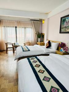 Postel nebo postele na pokoji v ubytování DH Sapa Hotel & Travel