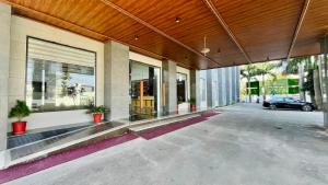 een gebouw met een auto geparkeerd op een parkeerplaats bij Le OVAL Hotel & Resorts in Nakraunda