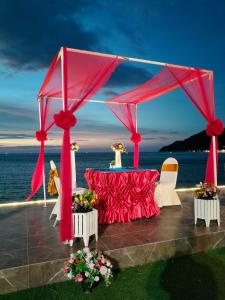 a tent with a table and chairs next to the ocean at Chang Buri Resort & Koh Chang Hillside in Ko Chang