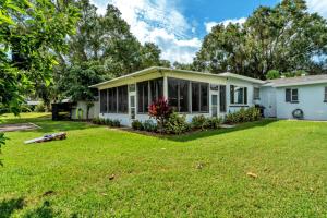 a white house with a large yard at Sunrise on Lake Idylwild in Winter Haven