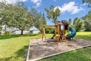 a playground with a slide in a park at Sunrise on Lake Idylwild in Winter Haven