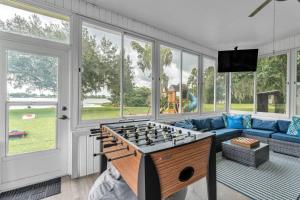a living room with a foosball table at Sunrise on Lake Idylwild in Winter Haven