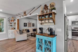 a kitchen and living room with a blue island at Sunrise on Lake Idylwild in Winter Haven