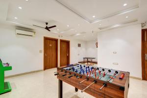 a ping pong table in a room at Qotel Comfort Ashok Vihar in New Delhi
