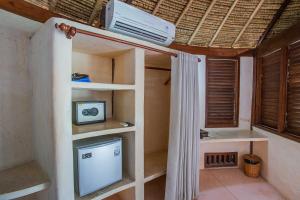 a room with a bunk bed with a tv at Sanghyang Bay Villas in Nusa Lembongan