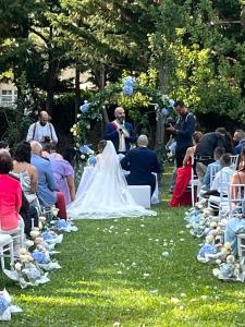 a bride and groom walking down the aisle at their wedding at B&B Villa degli Aceri in Carcare